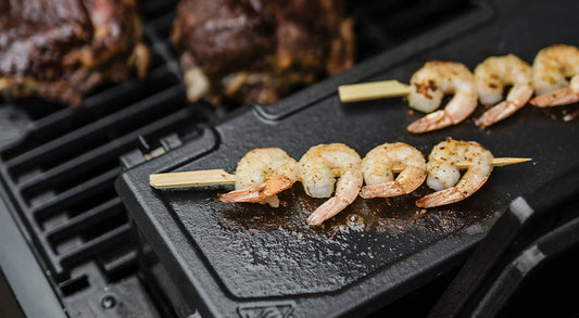 2 Shrimp skewers sear on the hopper sear plate of an AutoIgnite Series grill