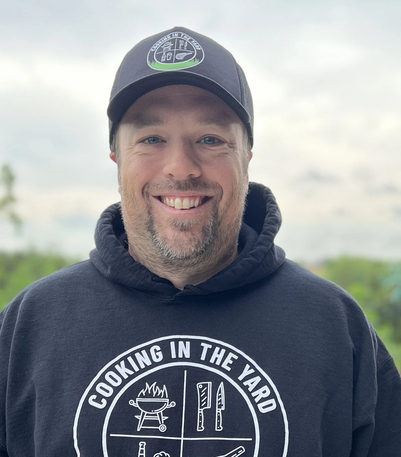 Danny Dobrzenski, wearing a Cooking in the Yard hoodie and hat