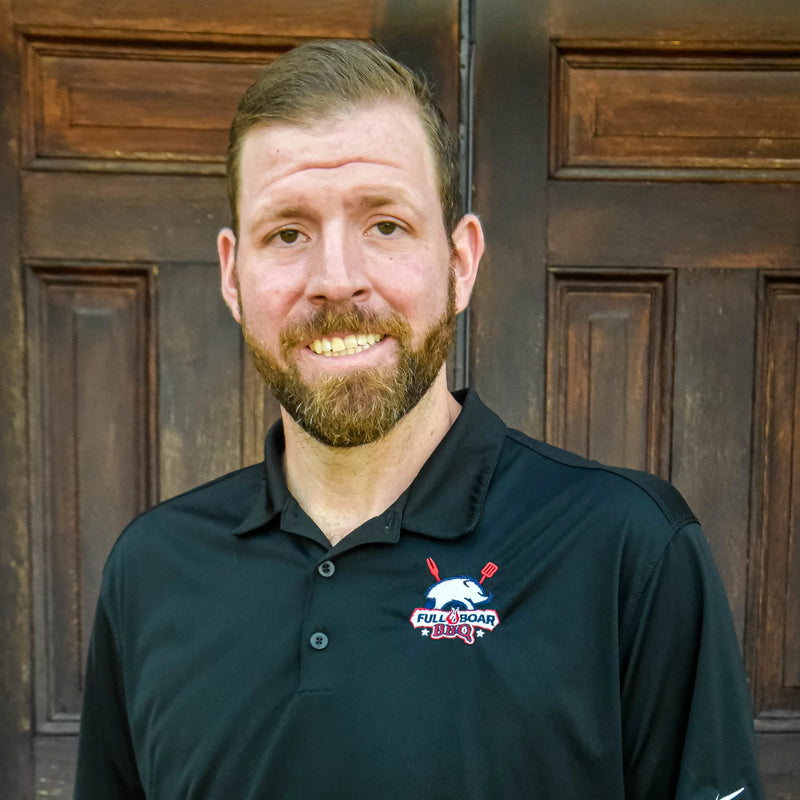 Jacob Lubbers headshot. Jacob is wearing a black polo shirt with the Full Boar BBQ logo embroidered on it.