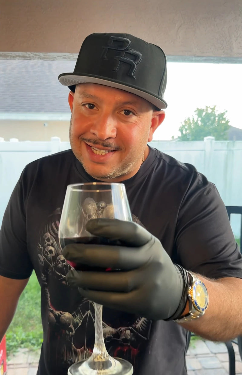 Joey Garcia toasts the viewer with a glass of red wine