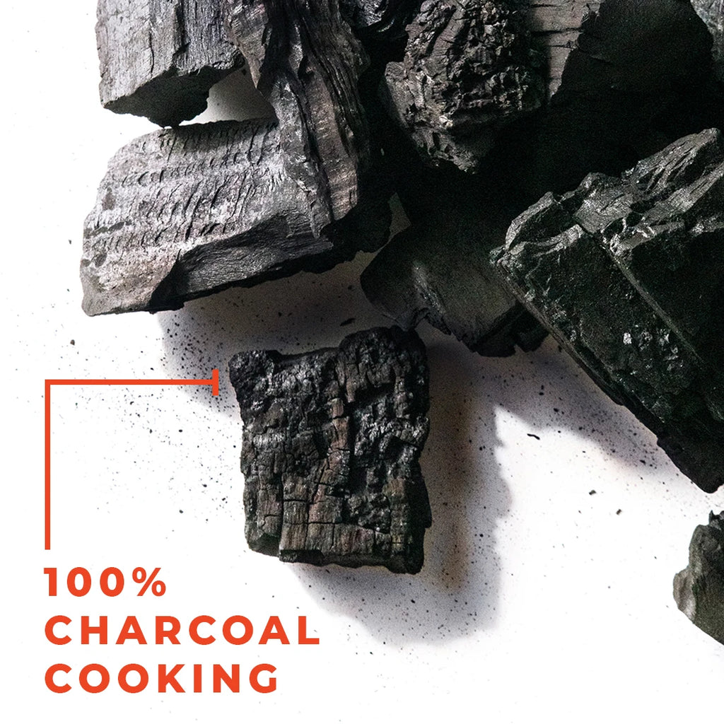 The words 100% charcoal cooking next to a pile of lump charcoal