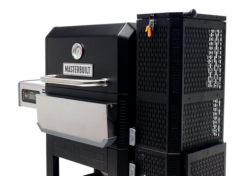 Angled view of a Gravity Series grill with stainless steel folding front shelf. The charcoal hopper is nearest the viewer. The digital control panel and side shelf are farthest from the viewer.