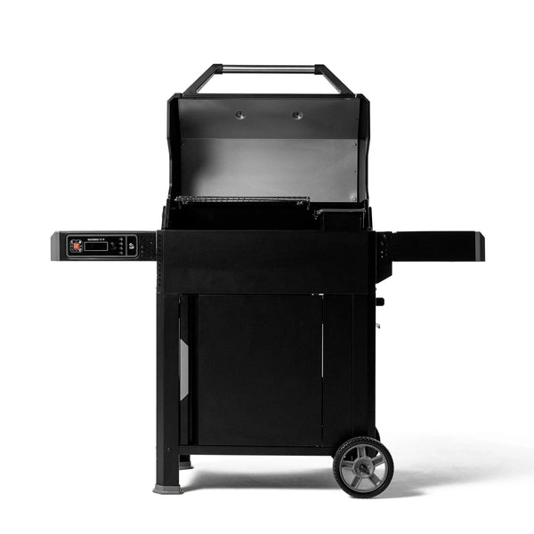An open AutoIgnite grill. The warming rack is on the left and the top of the charcoal hopper is visible on the right.