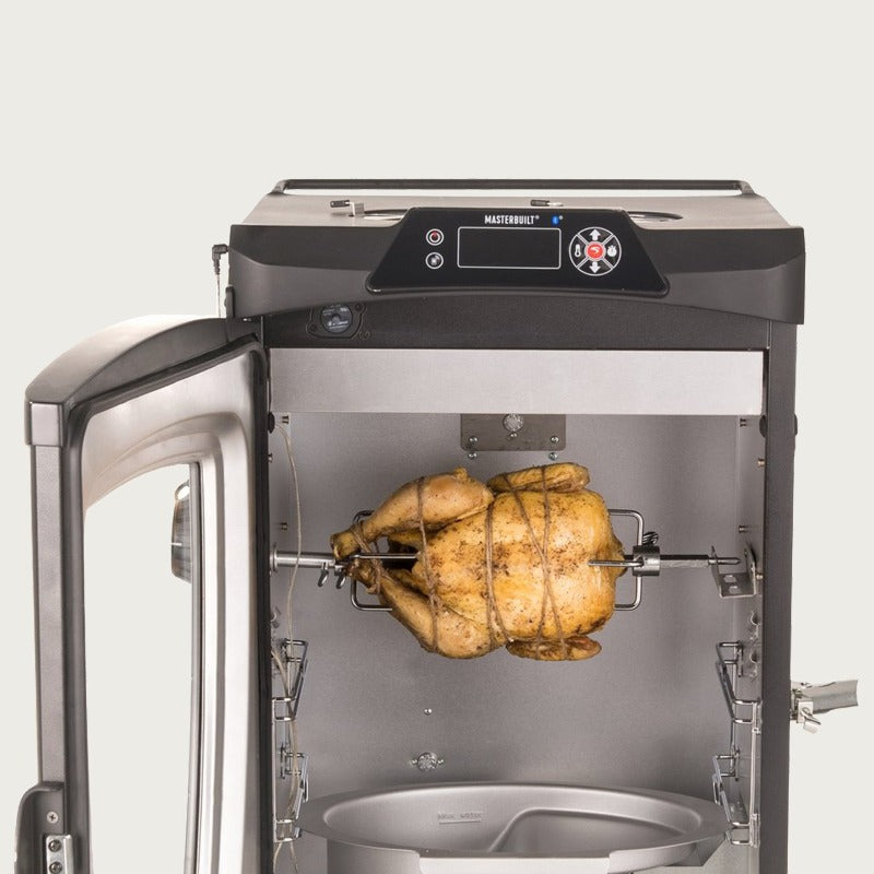 Chicken on electric rotisserie spit with meat hooks installed inside smoker cabinet